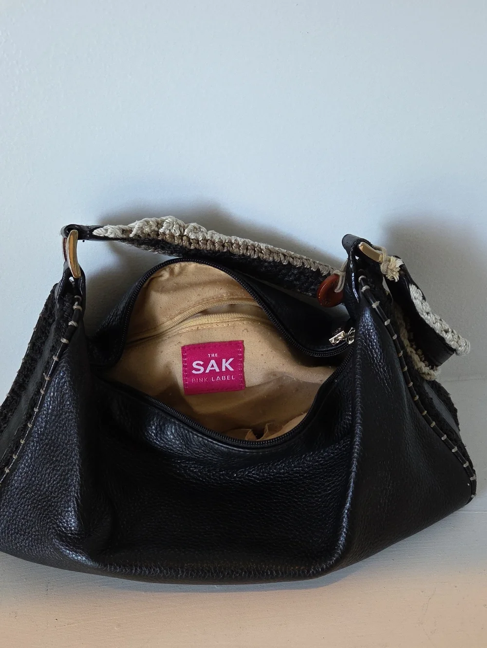 The Sak Pink Label knitted handle black leather handbag.